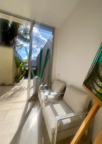a living room with a white couch and a large window at Casa de diseño en el Delta del Ebro in Amposta