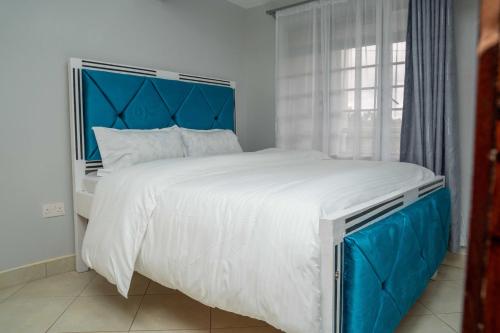 Ένα ή περισσότερα κρεβάτια σε δωμάτιο στο Marie Homes