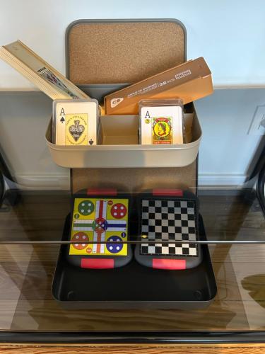 a toy desk with a chessboard and boxes on it at Plaza Teobaldos in Pamplona