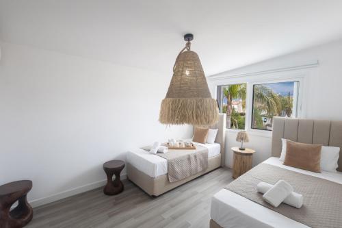 Un dormitorio con dos camas y una gran ventana. en EvelMar Villa, en Protaras