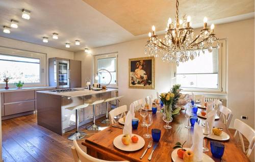 a dining room with a table and a chandelier at Gorgeous Home In Gianico in Artogne