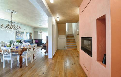a dining room and living room with a dining table at Gorgeous Home In Gianico in Artogne