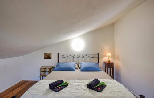 a bedroom with a bed with two pillows on it at Gorgeous Home In Gianico in Artogne