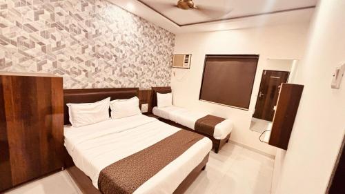 Ein Bett oder Betten in einem Zimmer der Unterkunft Hotel Garden Palace