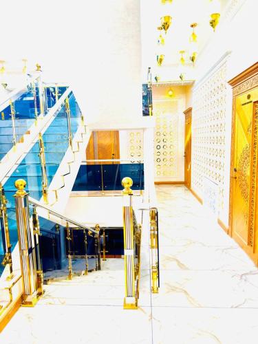 a staircase in a building with yellow and blue at Turon Khiva in Khiva