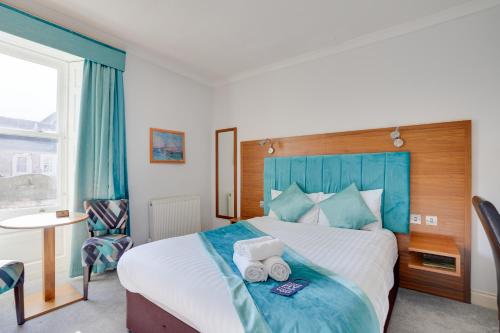 a hotel room with a bed with towels on it at The County Hotel - Self Check-In, Ultra Fast WI-FI, Free Parking, Central Location in Selkirk