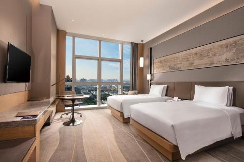 Doubletree By Hilton Suzhou Wujiangにあるベッド