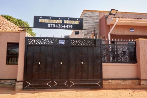 a black gate in front of a building at Freetown resort-Gulu in Gulu