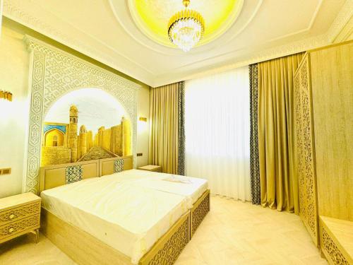 a bedroom with a bed with a painting on the wall at Turon Khiva in Khiva