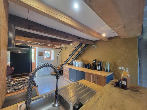 a kitchen with a sink and a stove top oven at La Grange de Capucine, gite de caractère in Chainaz-les-Frasses