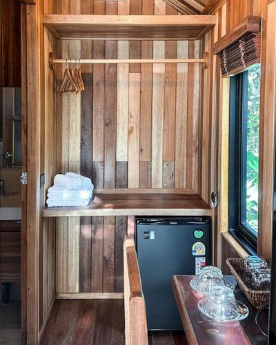 a small kitchen with a dishwasher and a table at Lush inn Phuket in Ban Suan