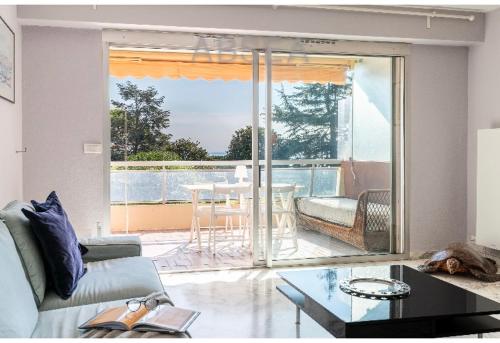 un salon avec un canapé et une table dans l'établissement Bells terres Nice grand appartement vue mer et jardin,piscine, à Nice