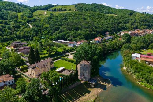 an aerial view of a small town next to a river at Santa Flora by PosarelliVillas in Capolona