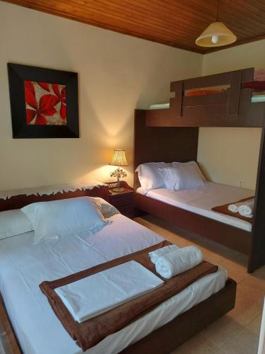 a bedroom with two beds and a bunk bed at Villa Maria in Roussakianá