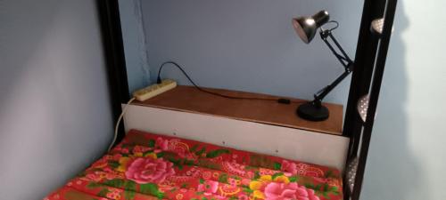 a desk with a lamp on top of a bed at Carpe Diem Guest House in Ko Chang