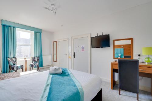 a hotel room with a bed and a desk and a computer at The County Hotel - Self Check-In, Ultra Fast WI-FI, Free Parking, Central Location in Selkirk