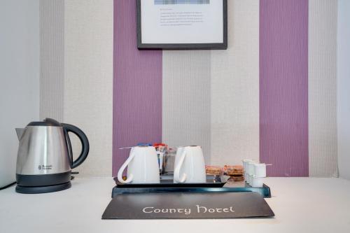 a counter with a couple of coffee pots on it at The County Hotel - Self Check-In, Ultra Fast WI-FI, Free Parking, Central Location in Selkirk