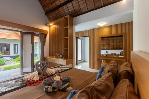 a living room with a couch and a large window at Bintang Bungalow in Nusa Penida