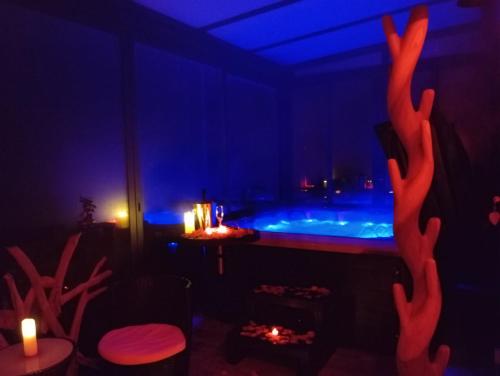 a room with a hot tub with blue lights at L'étincelle in Saint-Christol-lès-Alès