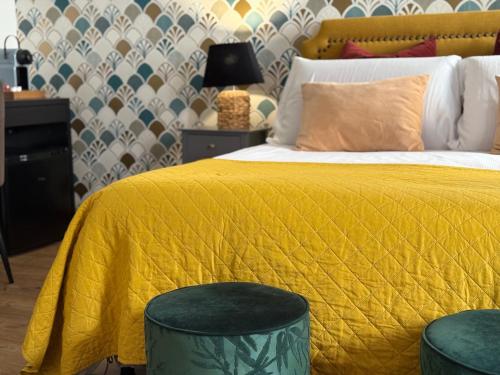 a bedroom with a bed with a yellow comforter at Palazzina300 in Treviso