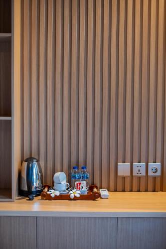 a wooden shelf with food and water bottles on it at Bintang Bungalow in Nusa Penida