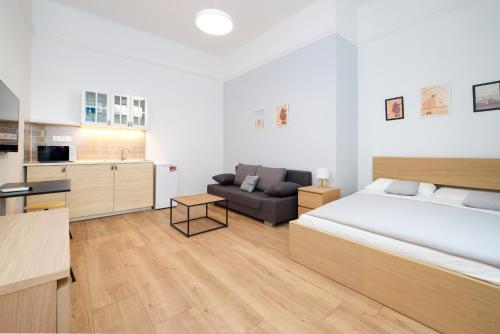 a bedroom with a large bed and a couch at Pillow Heaven King BB in Budapest