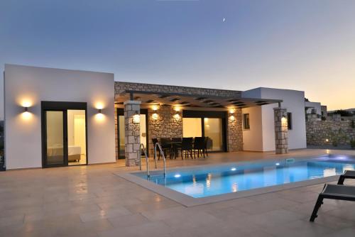 a swimming pool in the middle of a house at Sternes Tropicana Executive Villa with pool, by Comfortbnb in Sitia