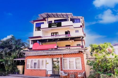 a tall building with a sign on it at Super Collection O Panjim Near Miramar Beach in Goa