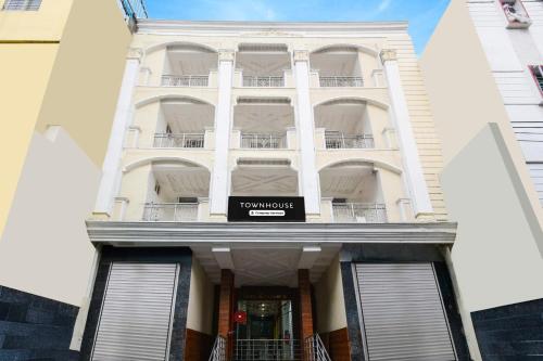 a white building with a sign on the front of it at Super Townhouse Raniganj formerly Devi Residency in Hyderabad