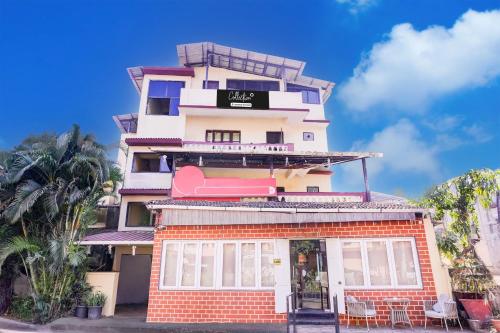 a tall building with a sign on it at Super Collection O Panjim Near Miramar Beach in Goa