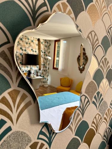 a bedroom with a bed and a mirror at Palazzina300 in Treviso