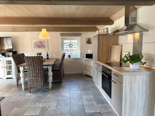 a kitchen with a table and a dining room at Ferienhaus Jeppe Hus Humptrup in Humptrup