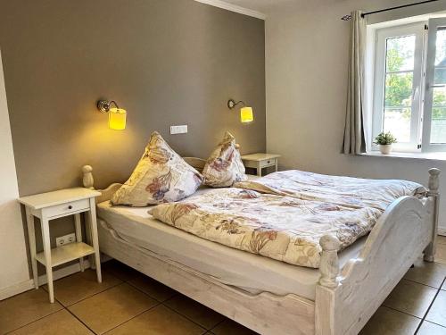 - une chambre avec un lit, 2 tables et une fenêtre dans l'établissement Ferienhaus Marie Rodenäs, à Rodenäs