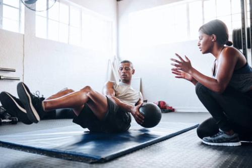 a man and a woman doing pushups in a gym at B&B SMARTFIT HOUSE - Room & Relax in Pescara in Pescara