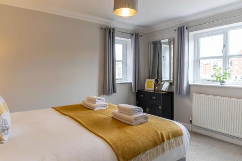 a bedroom with a bed with towels on it at Fair Winds in Whitby