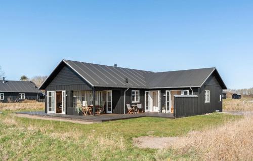 a black house with a black roof at 3 Bedroom Cozy Home In Nysted in Nysted