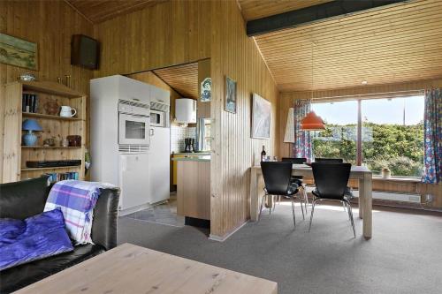 a kitchen and living room with a table and chairs at Sea view and nature in beautiful Lønstrup in Lønstrup