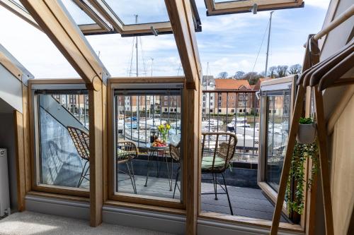 a balcony with a view of a marina at Fair Winds in Whitby
