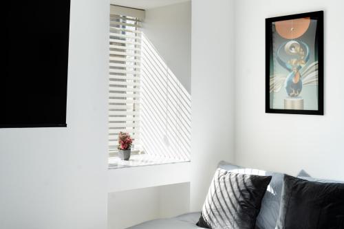 a living room with a window and a couch at Open Mind Property - Cozy Flat for FOUR in Bognor Regis