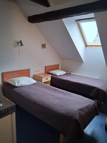 Postel nebo postele na pokoji v ubytování Hommiku Guesthouse