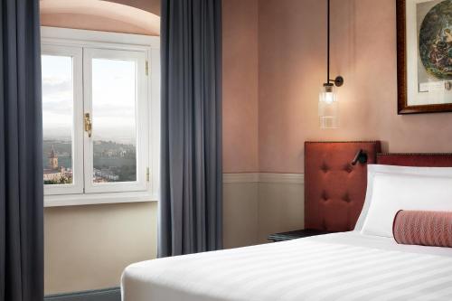 a hotel room with a bed and a window at Sina Brufani in Perugia