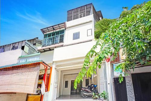 a motorcycle parked in front of a building at Hotel O Mandala Near Universitas Negeri Medan UNIMED in Medan