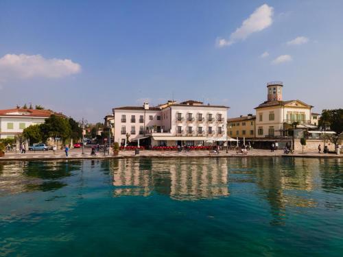 a large body of water in a city with buildings at La Vista Postcard Hotel in Lazise