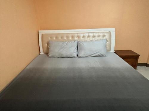 a bed with two pillows on it in a room at Comfort Haven Guesthouse in Bengcag