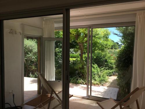 d'une porte coulissante en verre offrant une vue sur le jardin. dans l'établissement L'Oasis in Mèze,, à Mèze