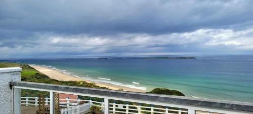 a view of a beach from a balcony at Royal Court Hotel in Portrush