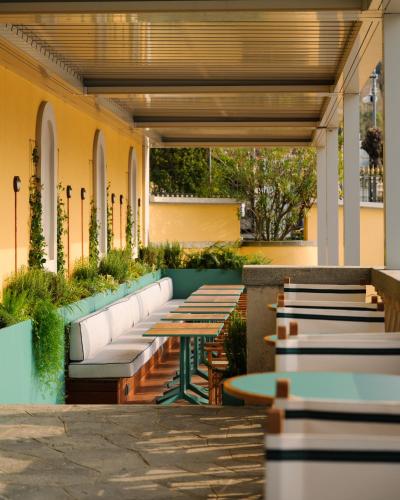 a row of tables and benches on a patio at Grand Hotel Villa Serbelloni - A Legendary Hotel in Bellagio