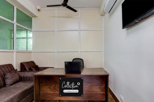 a living room with a couch and a table at Super Collection O Kukatpally S Palace in Madhapur