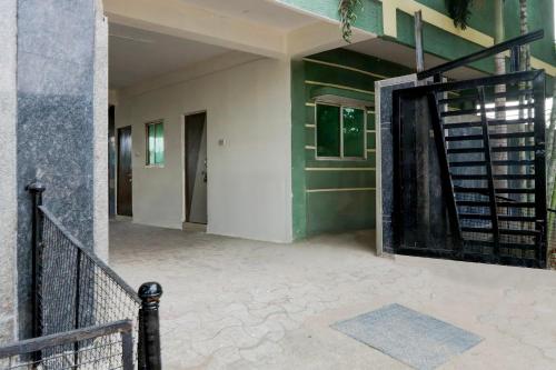 an open door of a house with a staircase at Super Collection O Kukatpally S Palace in Madhapur