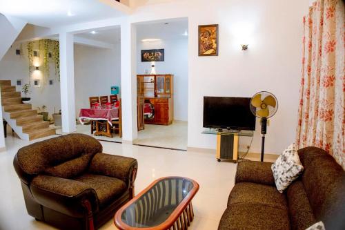 a living room with a couch and a tv at Villa viola resort in Marawila